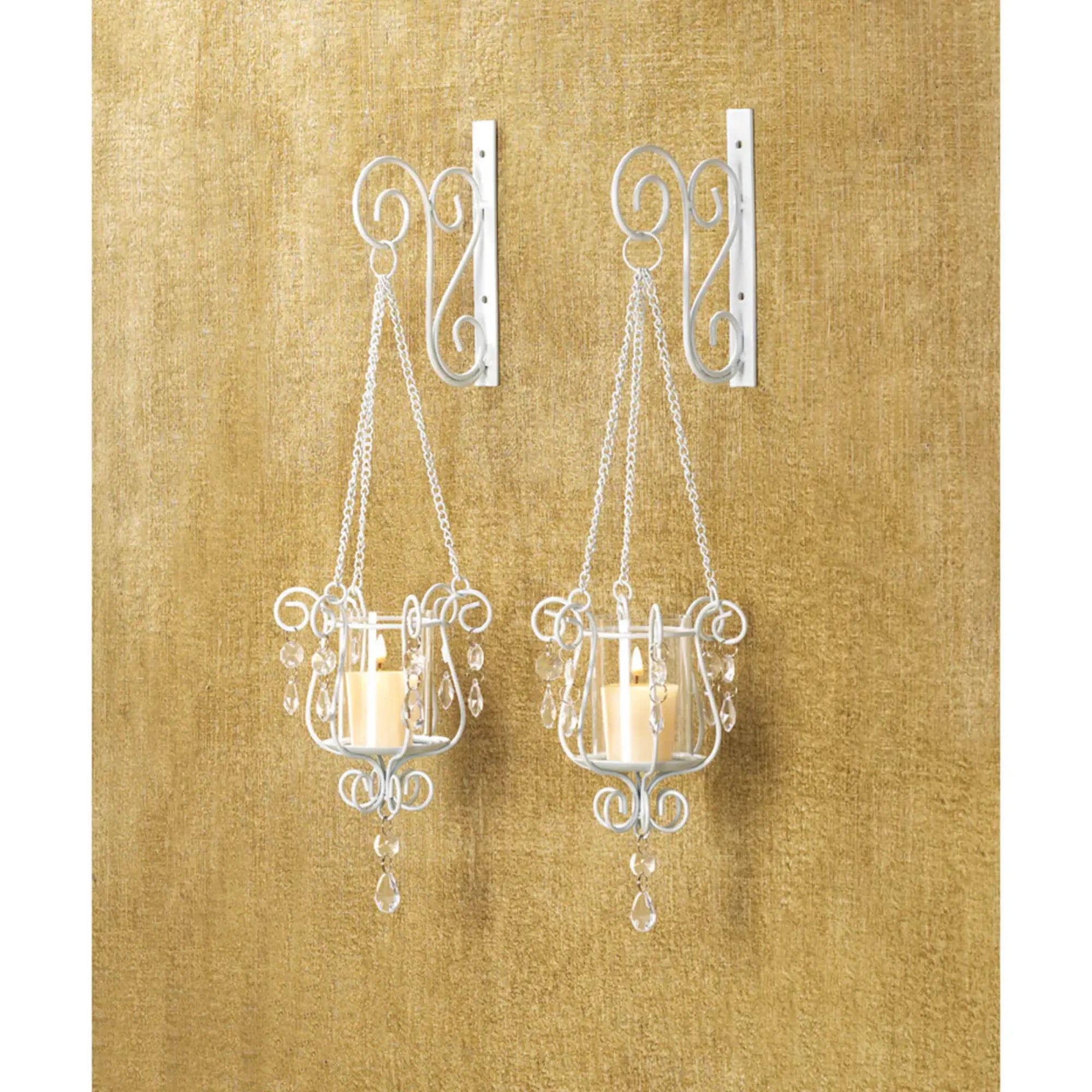 Two hanging candle holders with decorative metalwork on a gold textured background