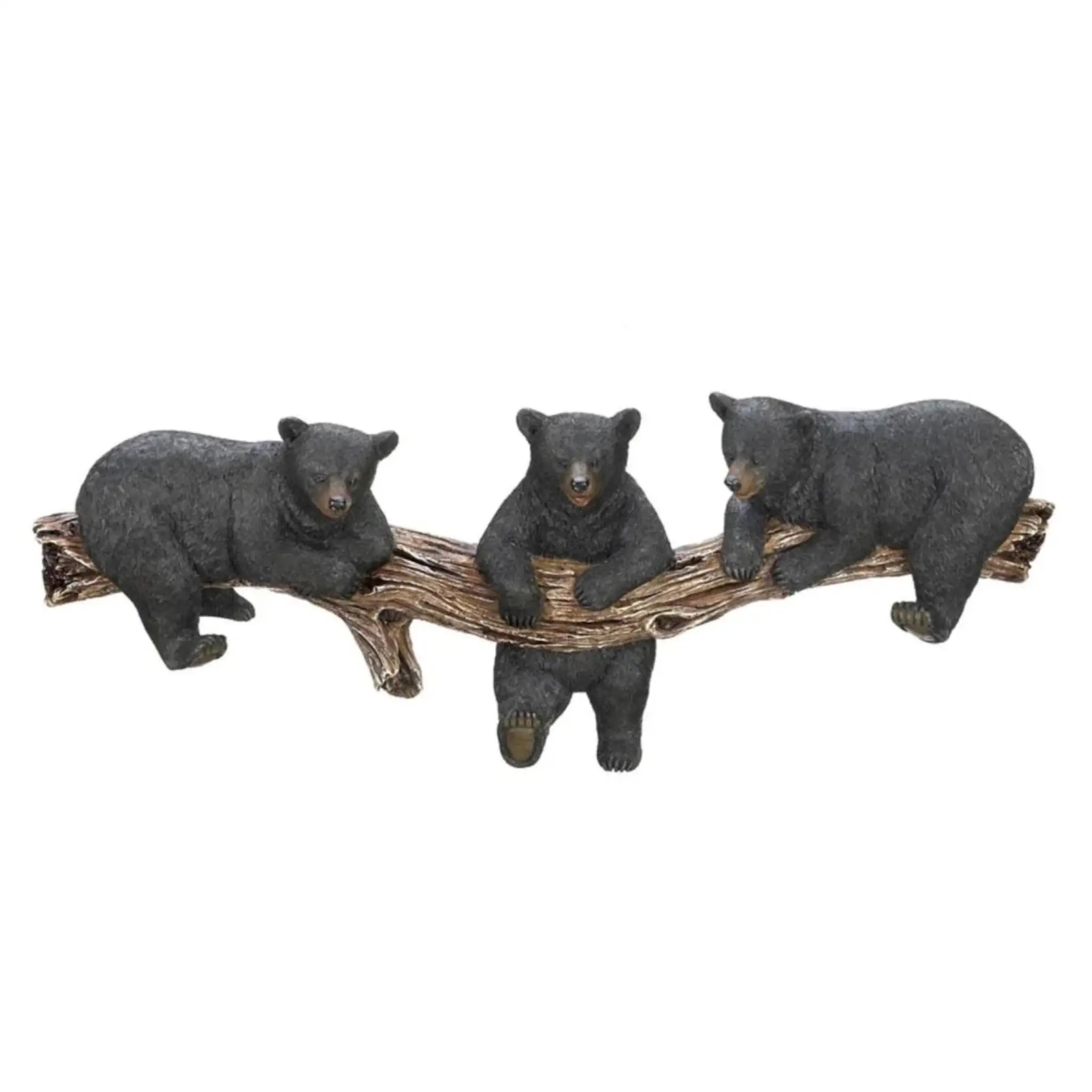 Three bear wall hook figurines sitting on a branch against a white background