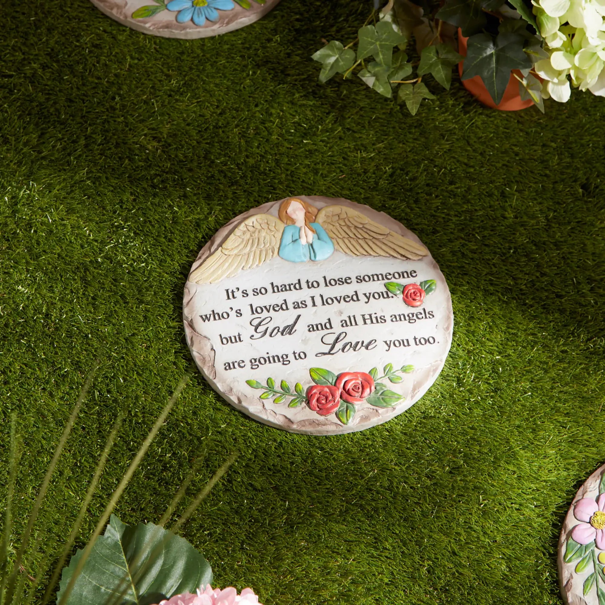 Angel memorial cement stepping stone with quote on grass