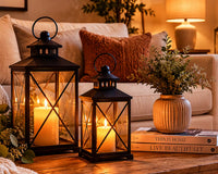 Decorative candle lanterns on a coffee table adding warm ambient lighting to a cozy living room.