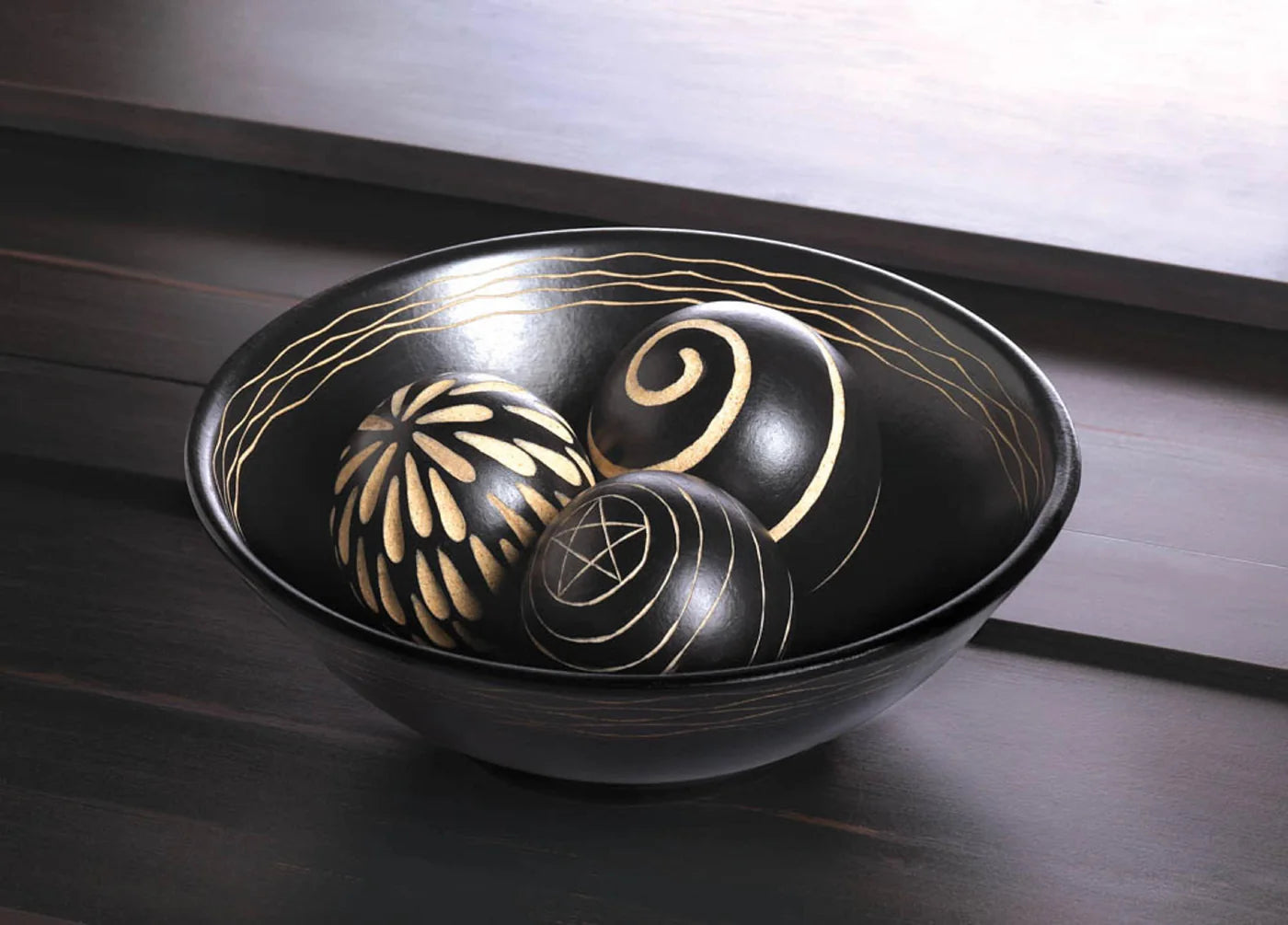 Round decorative bowl with three carved spheres in a sculptural display