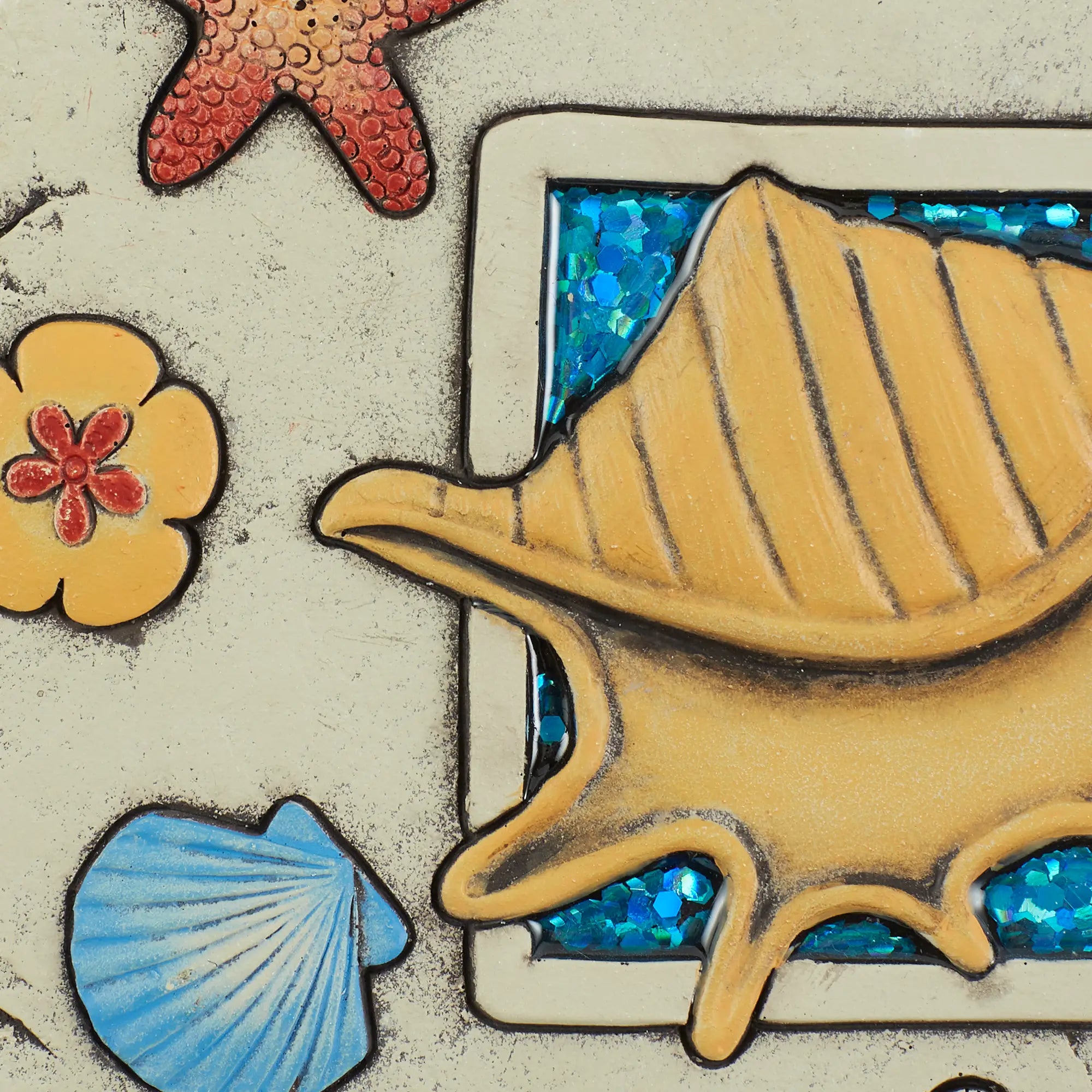Close-up of shell and glitter detail on Enjoy Life’s Blessings garden stepping stone