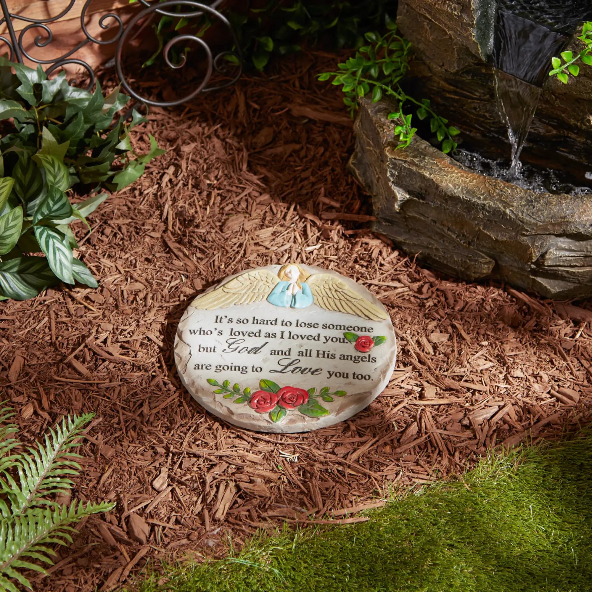 Angel memorial cement stepping stone with quote on mulch background