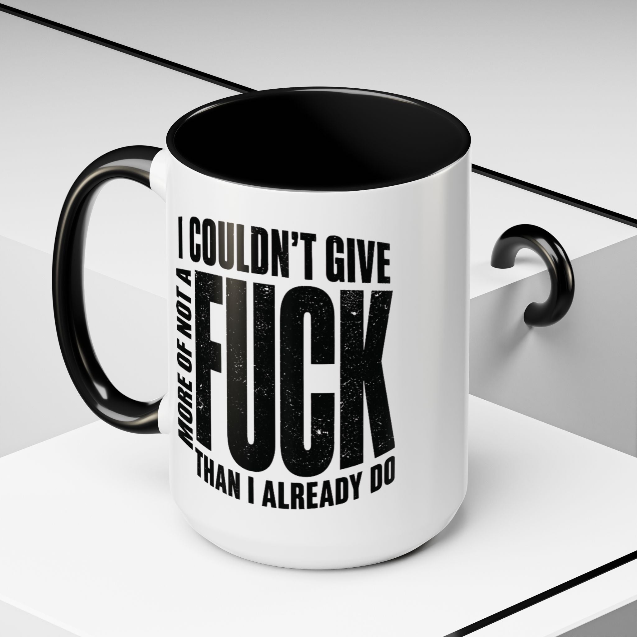 Funny coffee mug with black interior and handle, featuring a bold text design on a lifestyle background.