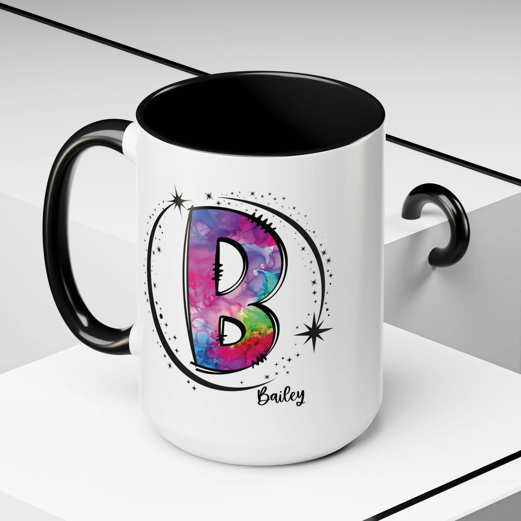 White monogram mug with black handle and interior featuring a colorful letter B design and custom name on decorative background