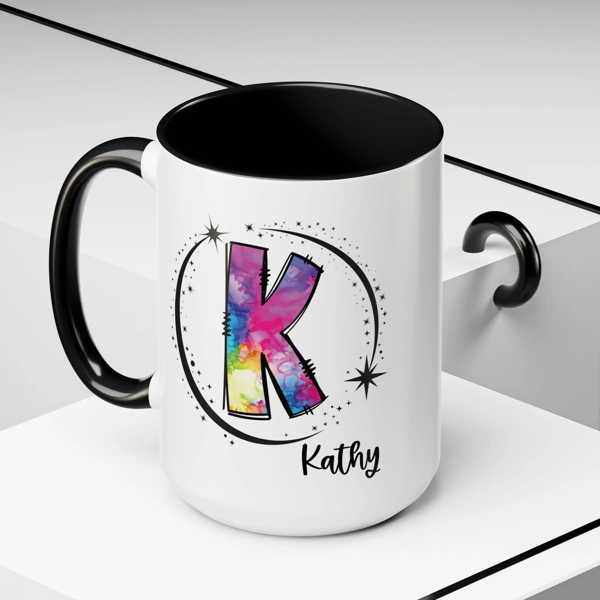 Monogram mug with black handle and interior featuring a colorful letter K design and custom name against decorative background