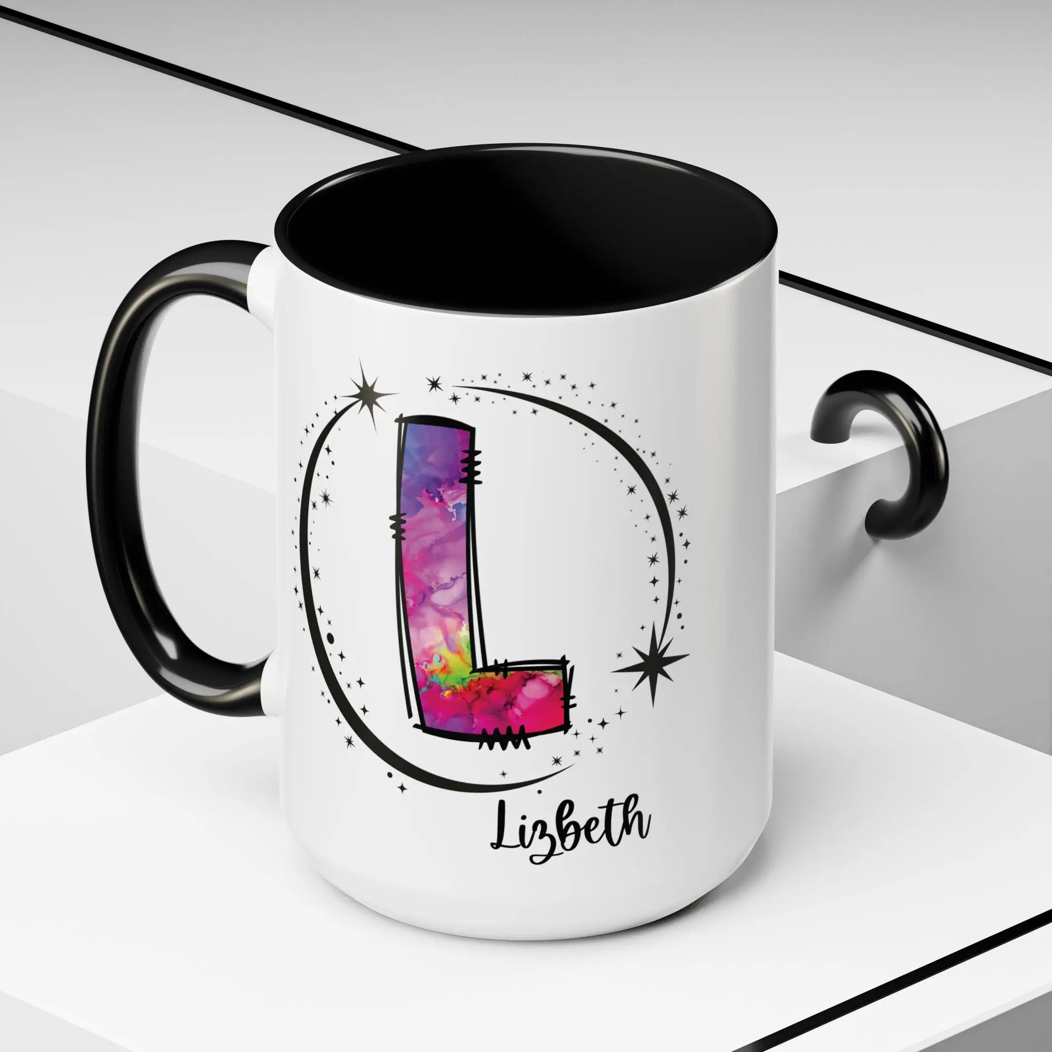 White monogram mug with black handle and interior featuring a colorful letter L design and custom name on decorative background