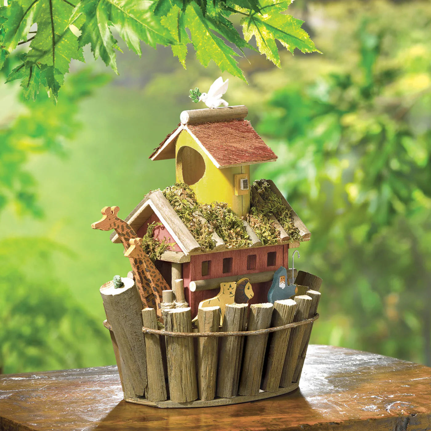 Wooden birdhouse with decorative elements on a table outdoors