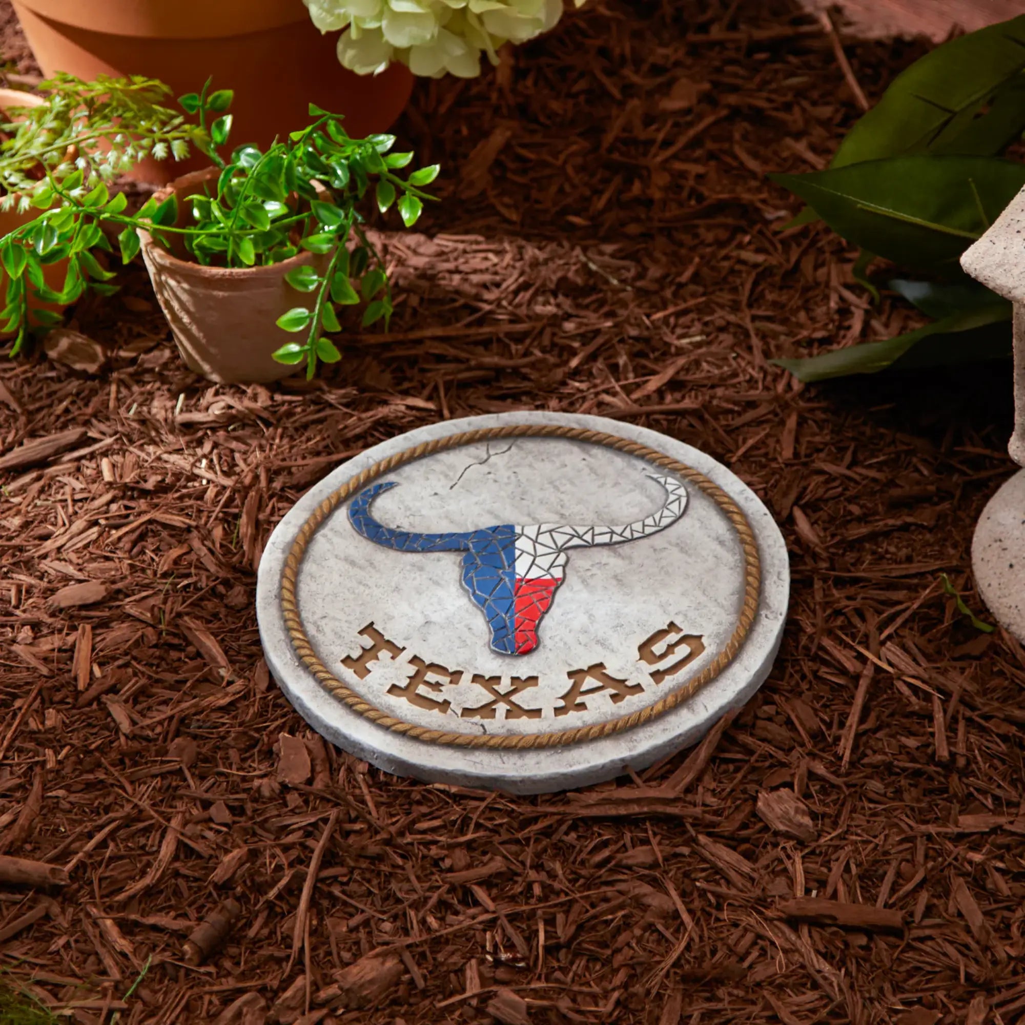 Garden stepping stone with Texas flag design on mulch