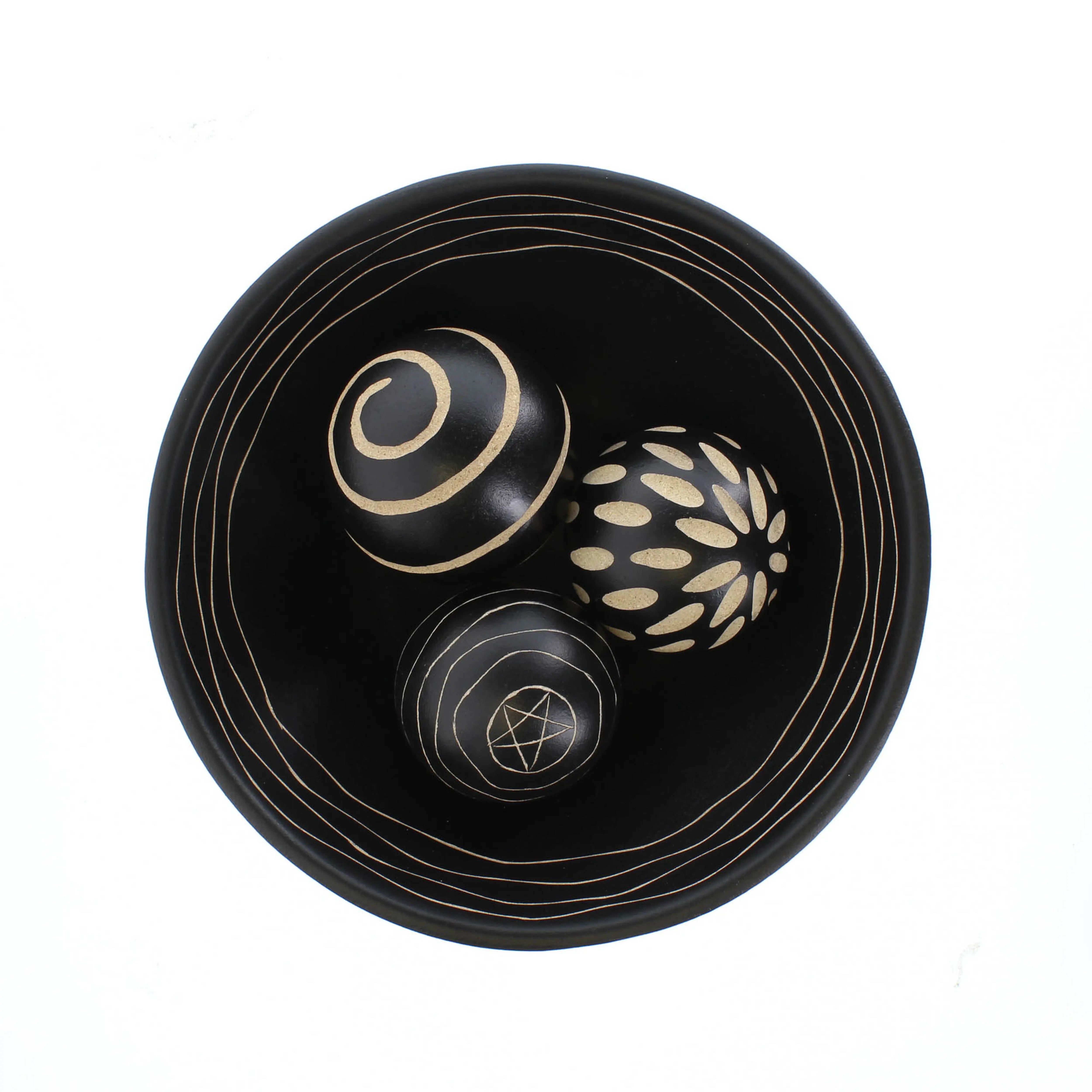 Decorative bowl with three decorative balls featuring geometric patterns on a white background